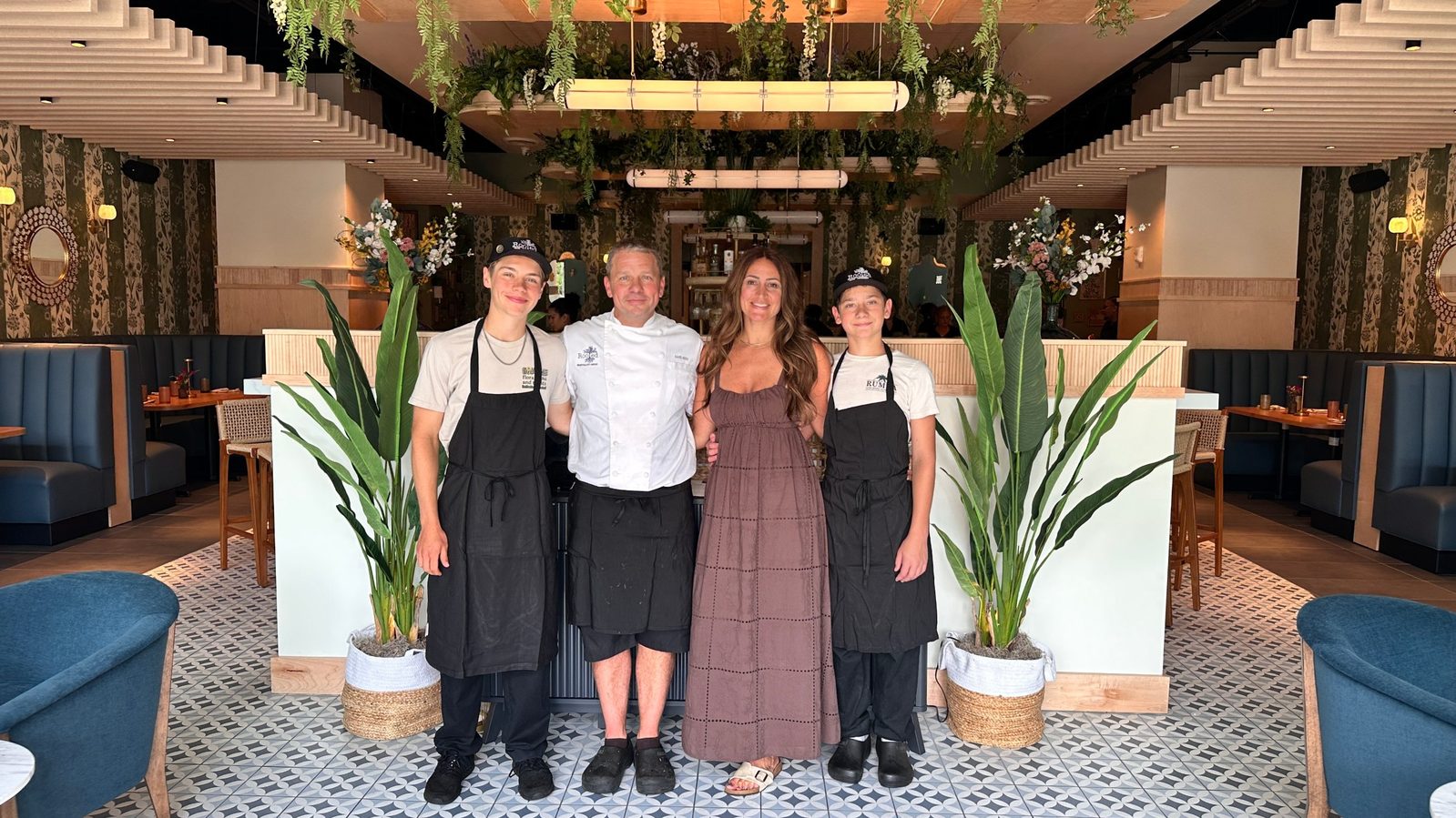 Rooted Hospitality Group co-founders David and Rachel Hersh with their sons Jude and Shayd inside the dining room at flora Charlotte in South End