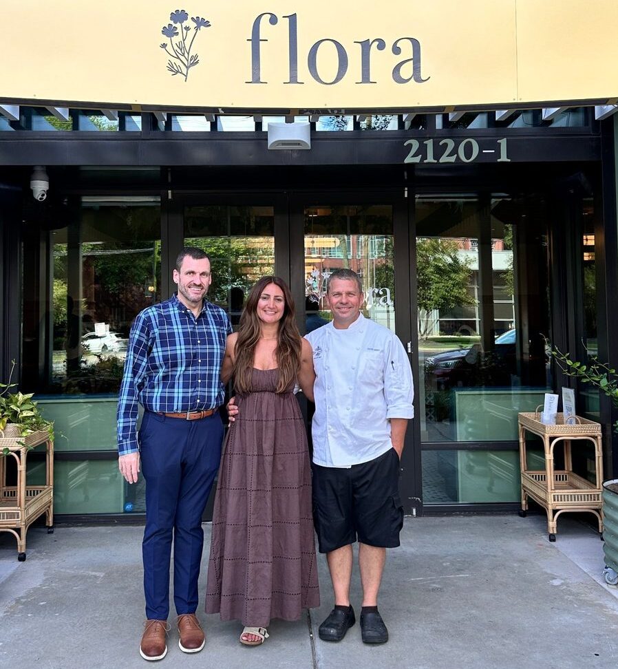 Rooted Hospitality Group COO Gerald Hilburn with co-founders Rachel and David Hersh outside flora Charlotte at 2120 South Blvd in Atherton Mill, South End